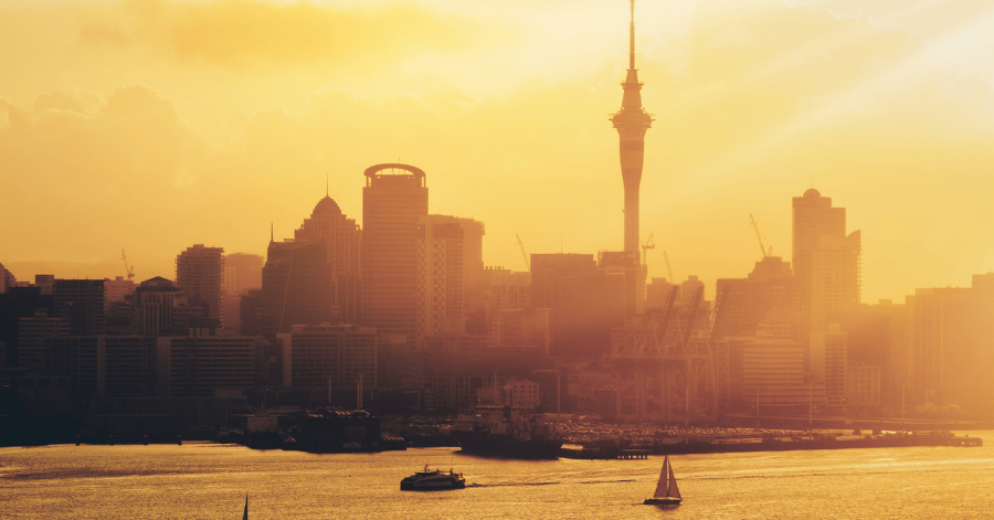 Auckland's Sky Tower and skyline at golden sunset over the Waitemata Harbour