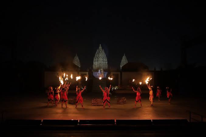 Dancers with flaming torches perform the Ramayana Ballet before floodlit Prambanan at night