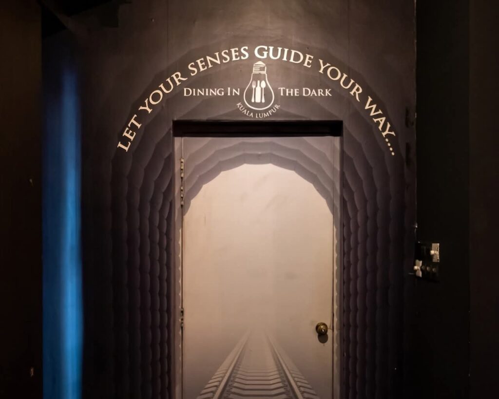 Dimly lit archway entrance to Dining In The Dark Kuala Lumpur