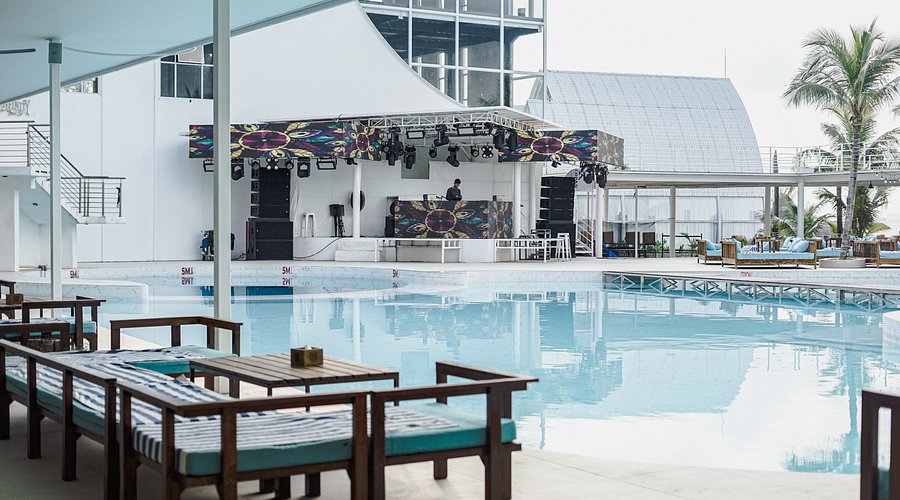 A poolside DJ stage and daybeds at a Gold Coast beach club, Batam