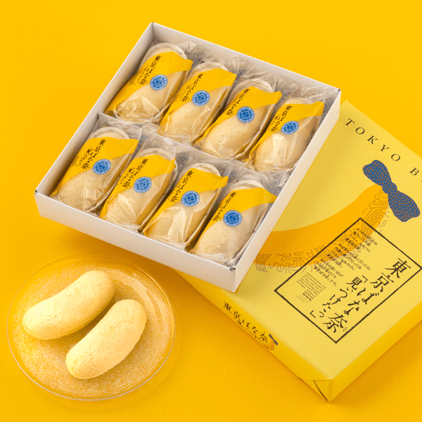 Boxed Tokyo Banana sponge cakes with custard filling, two on a plate
