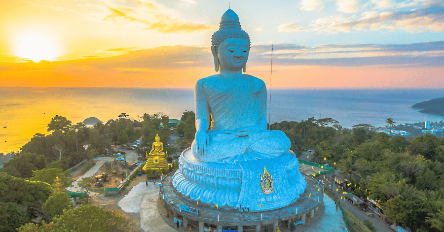 Phuket's white marble Big Buddha seated on the Nakkerd Hills at sunset