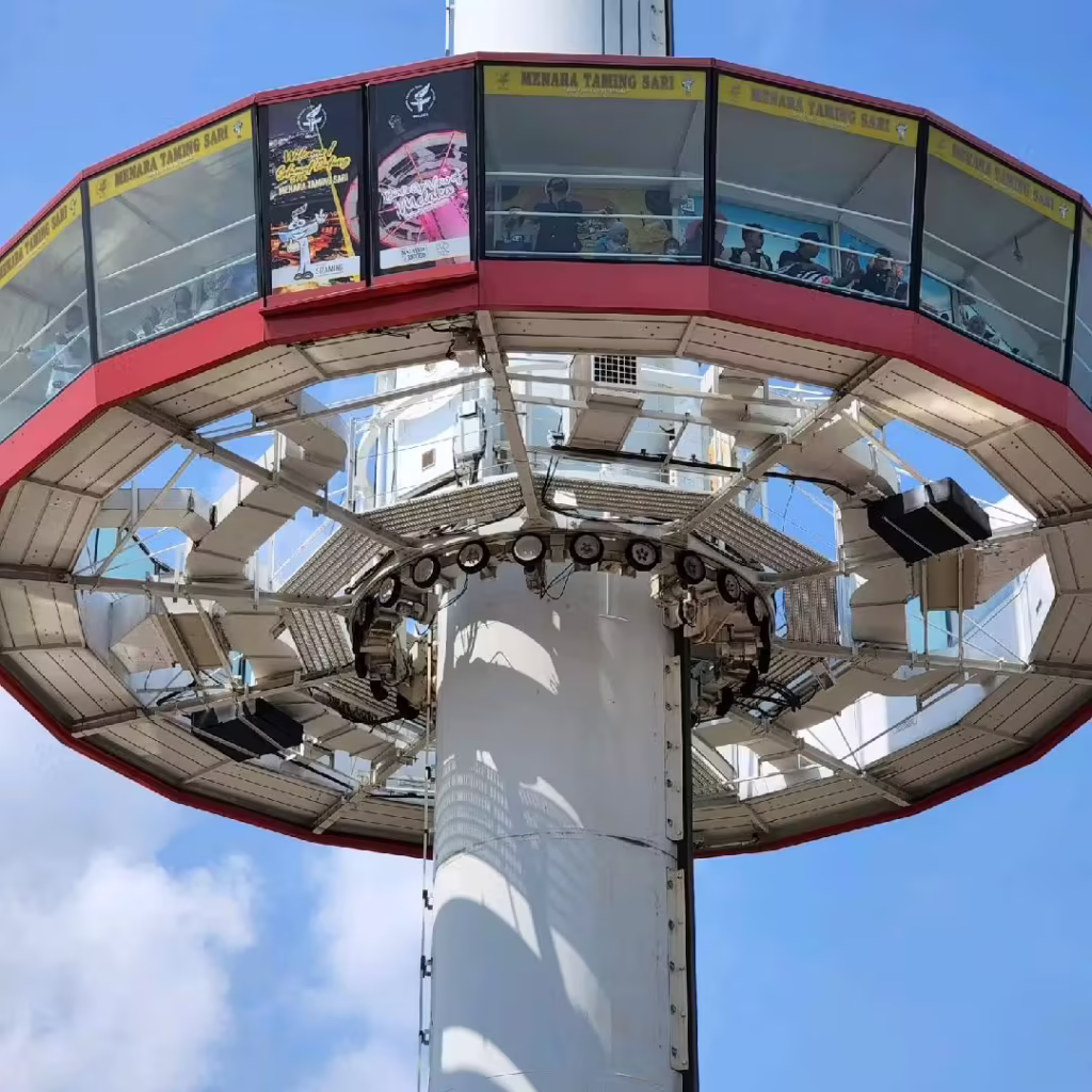 The circular viewing cabin of the Menara Taming Sari revolving tower against a blue sky