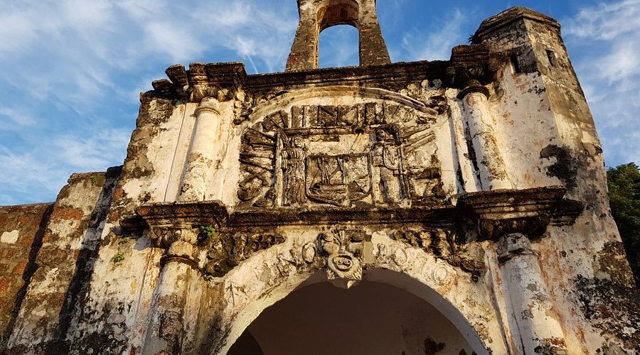 The weathered Porta de Santiago stone gateway, the surviving fragment of the A'Famosa fortress