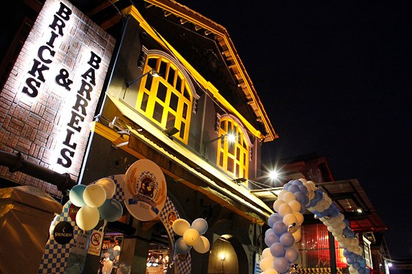 The lit exterior of the Bricks & Barrels bar in Ipoh's New Town at night