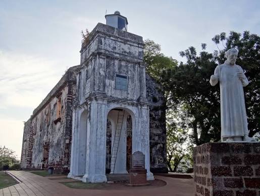 The roofless stone ruins of St Paul's Church beside the St Francis Xavier statue on St Paul's Hill