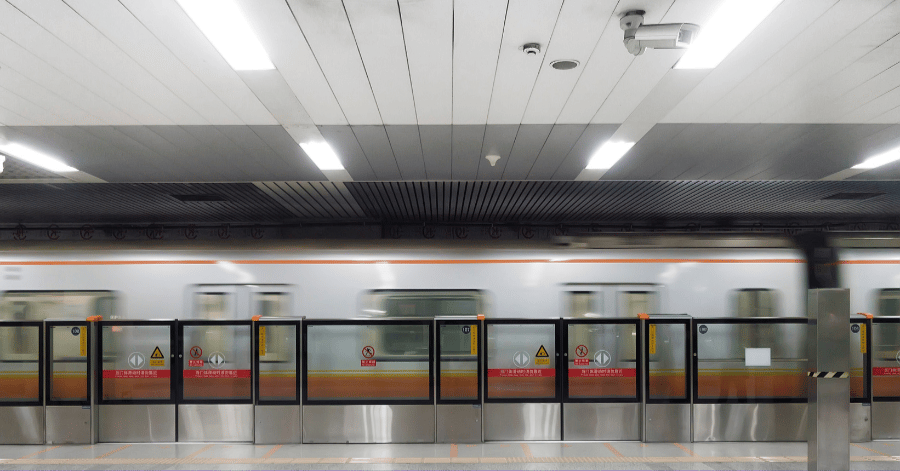 Beijing subway platform with platform-screen doors and a train waiting at the station