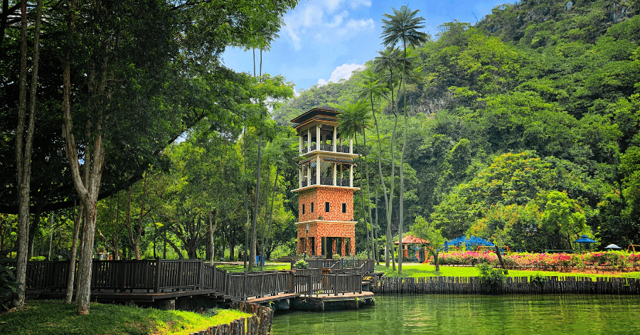 A brick lookout tower and boardwalk beside the lake at Gunung Lang Recreational Park, Ipoh