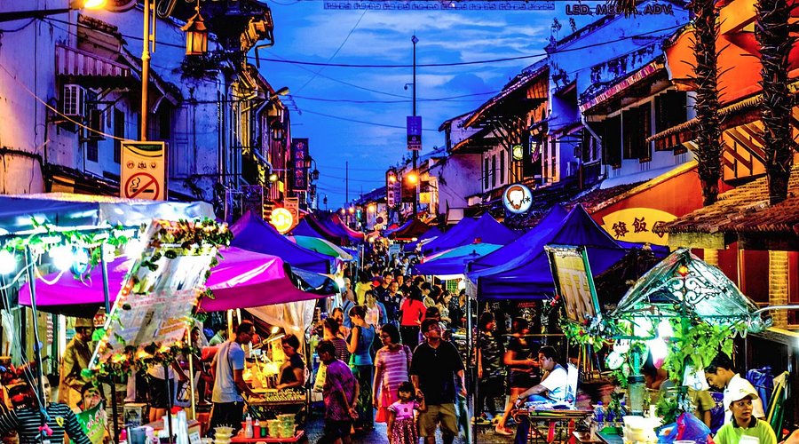Crowds and lit-up stalls filling Jonker Street during the weekend night market at dusk