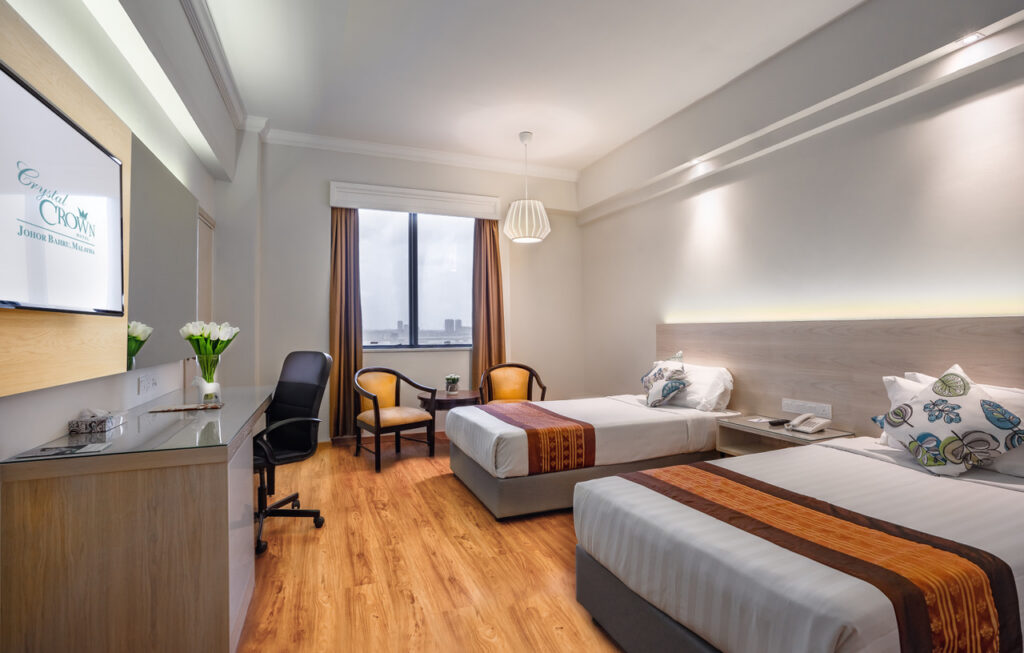 Crystal Crown Hotel twin-bed room with a work desk and a city-view window