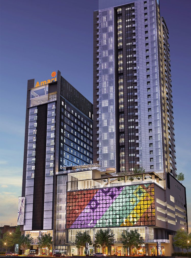 Amari Johor Bahru's twin towers above a colourful geometric podium at dusk