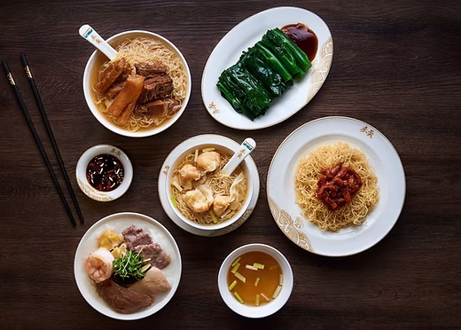 A spread of Hong Kong wonton noodle soup, shrimp-roe noodles, wontons and choy sum greens