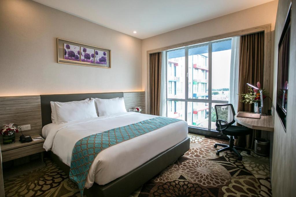 V8 Hotel guest room with a double bed, work desk and a window over the neighbourhood