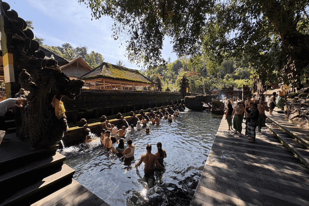Visitors taking part in the purification ritual at Tirta Empul's spring pools