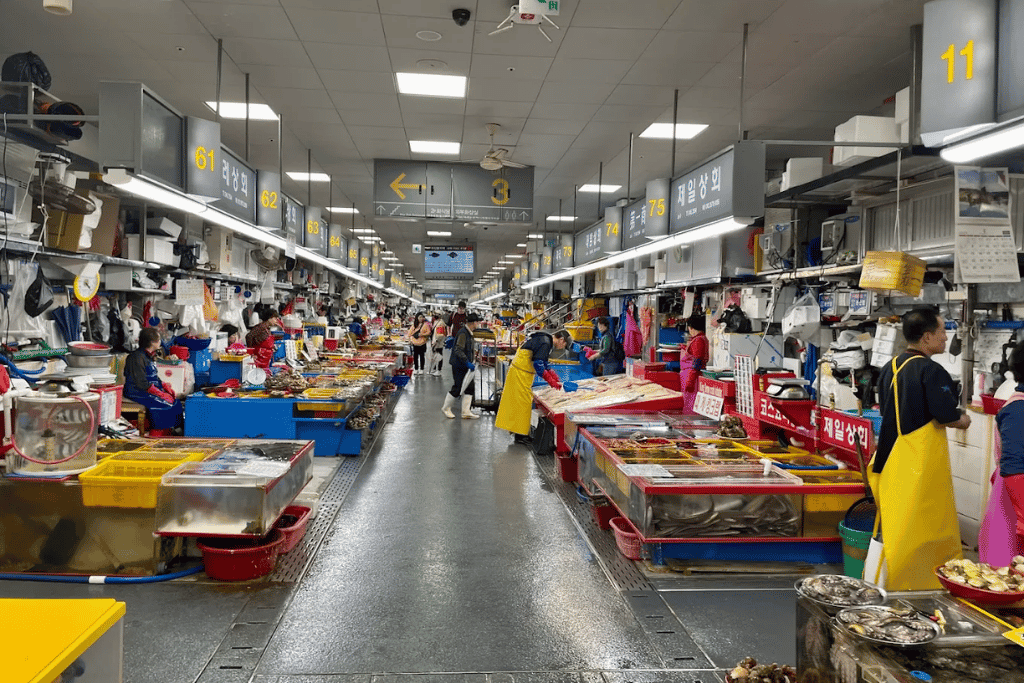 Seafood stalls lining an aisle inside Jagalchi Fish Market