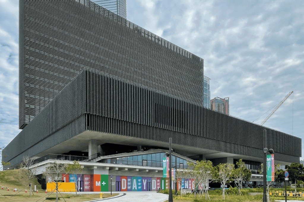 The long dark facade of the M+ contemporary art museum in the West Kowloon Cultural District