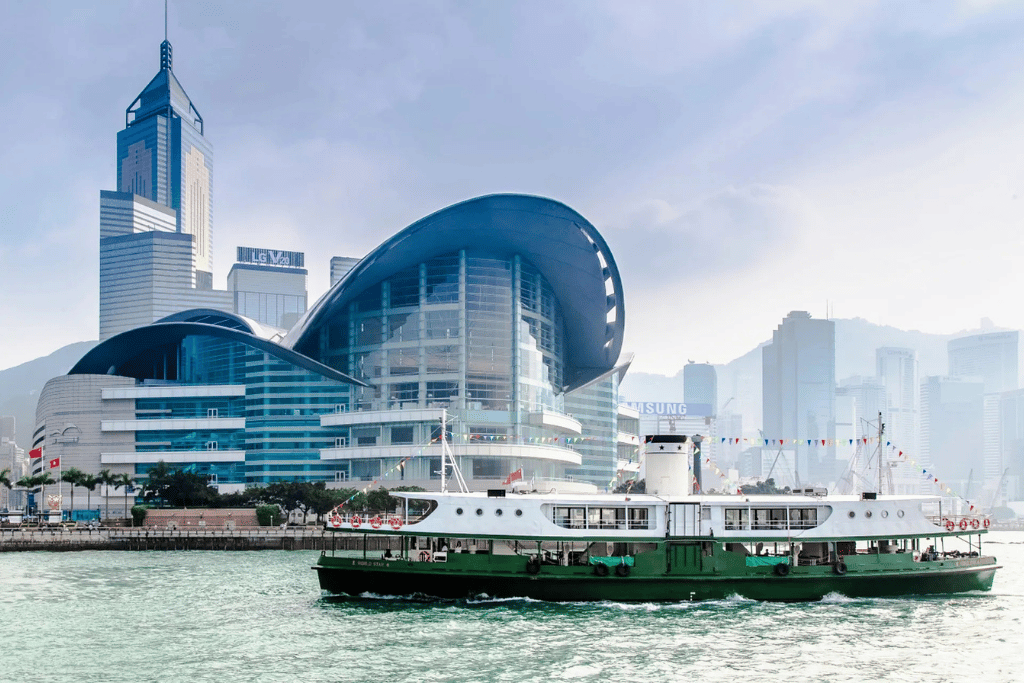 A white-and-green Star Ferry crossing Victoria Harbour in front of the Hong Kong skyline