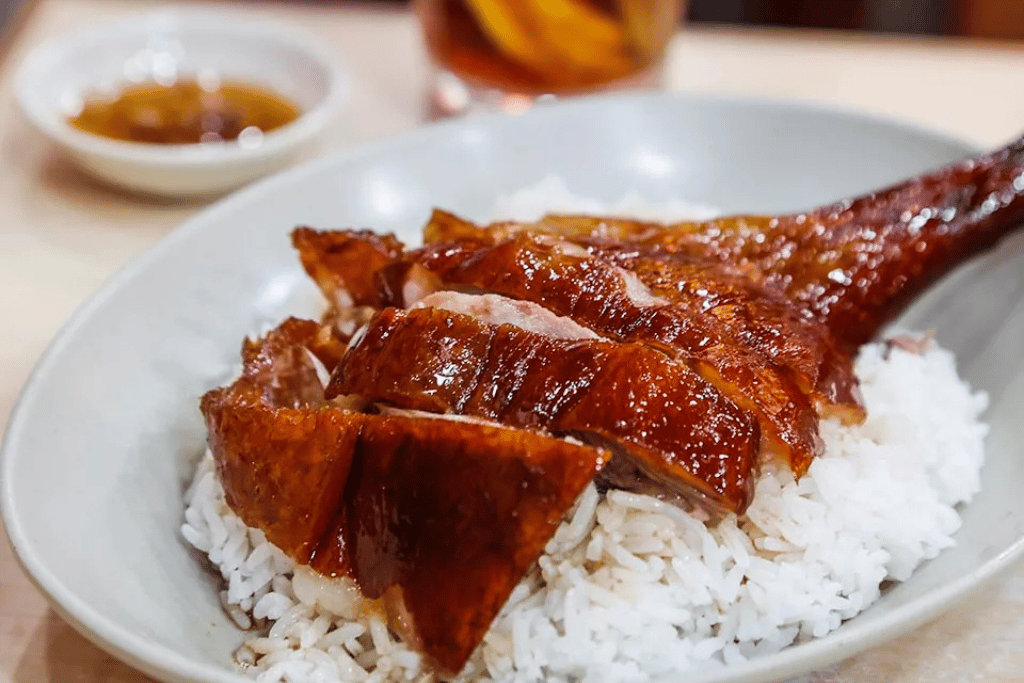 Crispy-skinned Cantonese roast goose served over a bowl of steamed rice