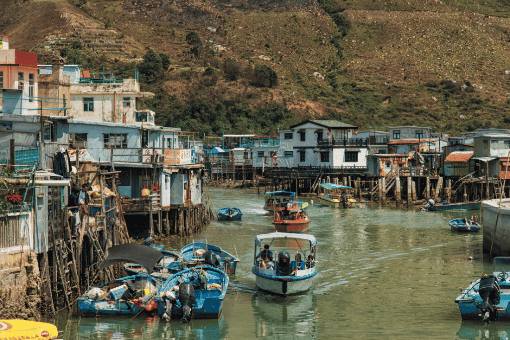 Stilt houses and moored fishing boats lining the waterway at Tai O fishing village, Lantau Island