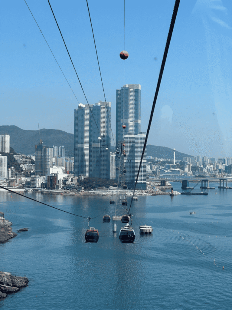 Cable car cabins crossing the bay toward Songdo's high-rises in Busan