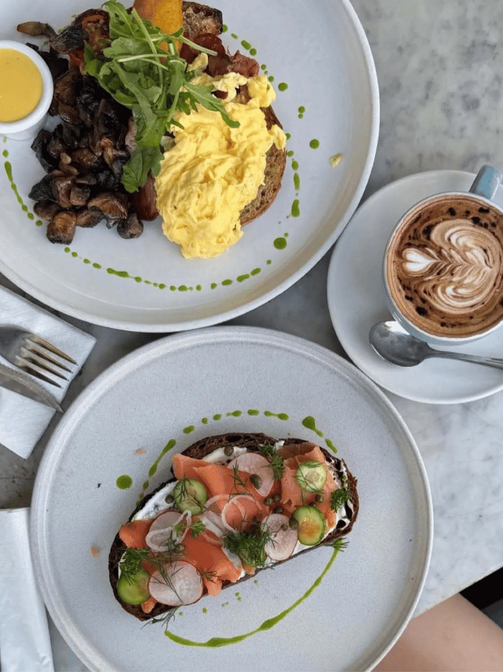 Brunch plates of eggs, avocado toast and coffee at a Seminyak cafe