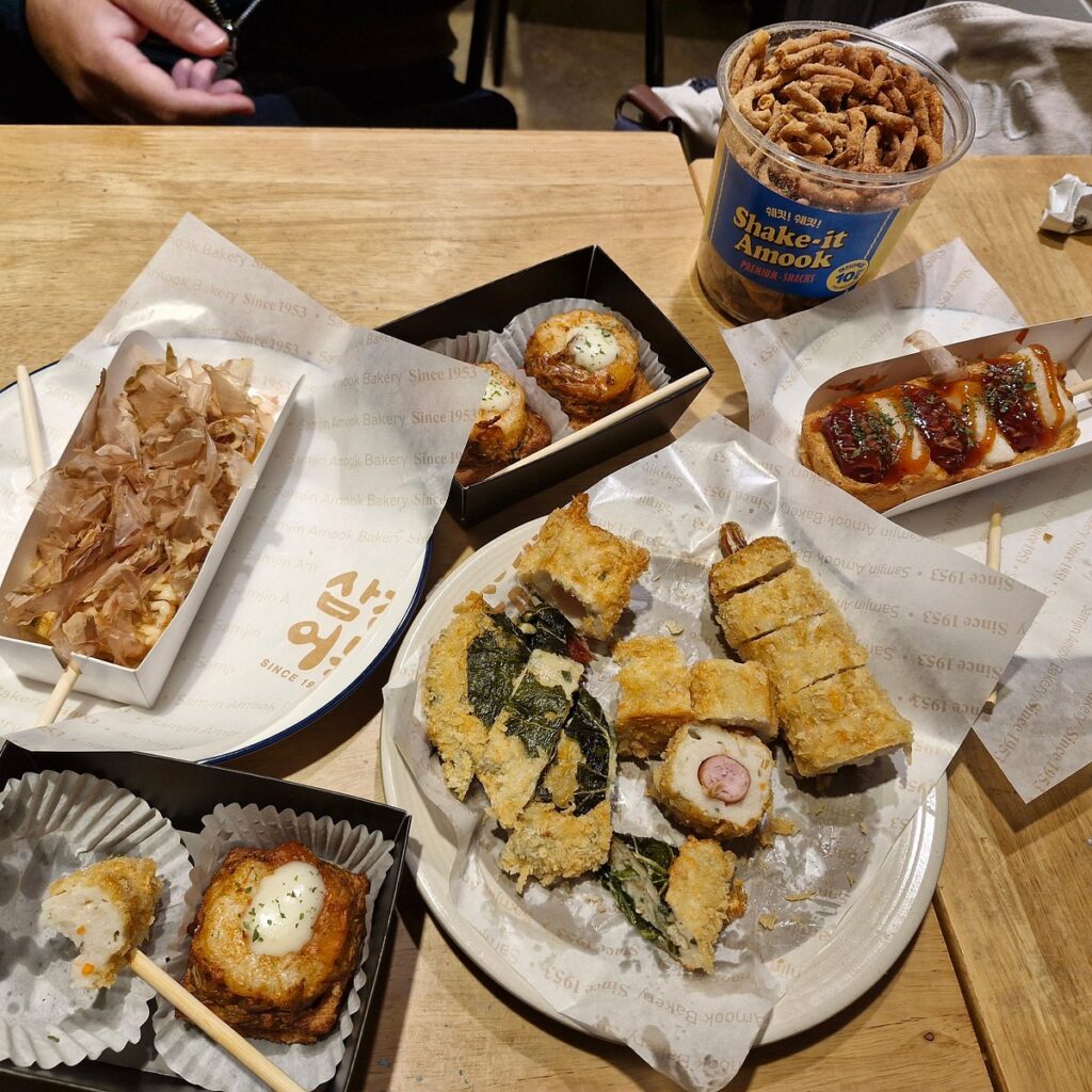 Assorted Busan eomuk fish-cake skewers and snacks on a table