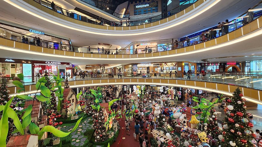 Multi-storey atrium of Mid Valley Southkey mall with festive decorations and shoppers