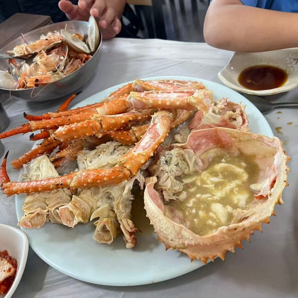 Plate of steamed crab legs and crab at a Busan seafood restaurant
