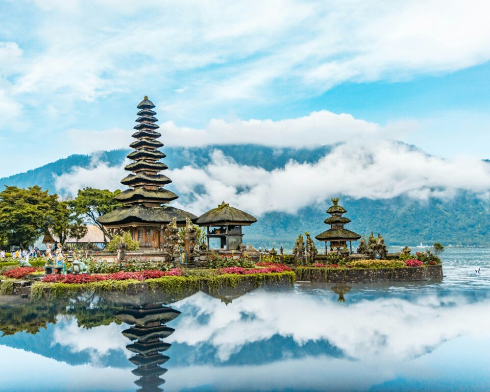 Tiered Ulun Danu Beratan temple reflected on a calm mountain lake, Bali