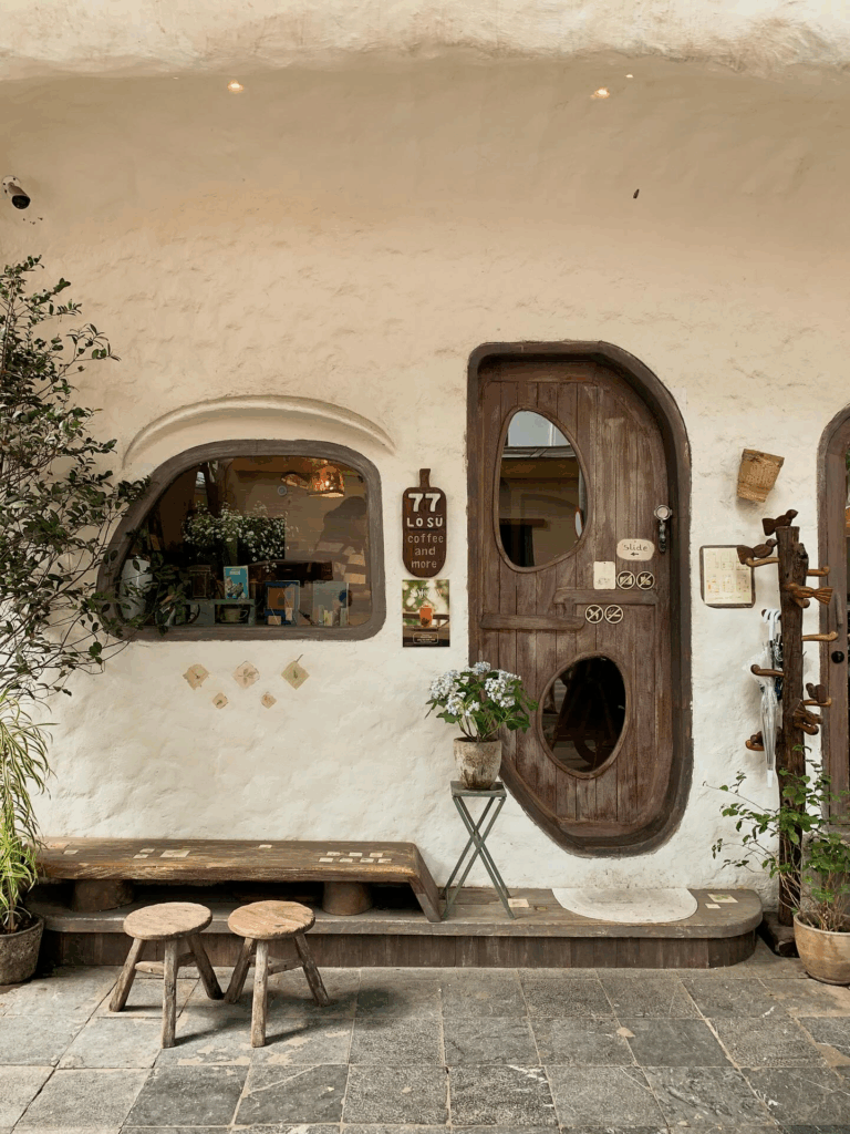 Curved cream interior and tucked-away seating nooks inside giao mua cafe