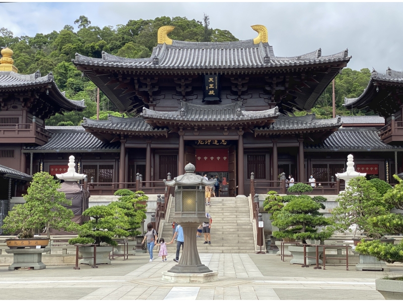 The wooden Tang-style main hall of Chi Lin Nunnery with bonsai and a stone lantern, Kowloon