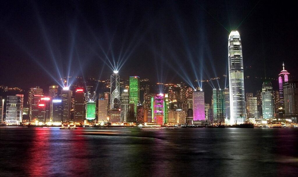 Laser beams sweeping over Hong Kong's illuminated skyline during the nightly Symphony of Lights show