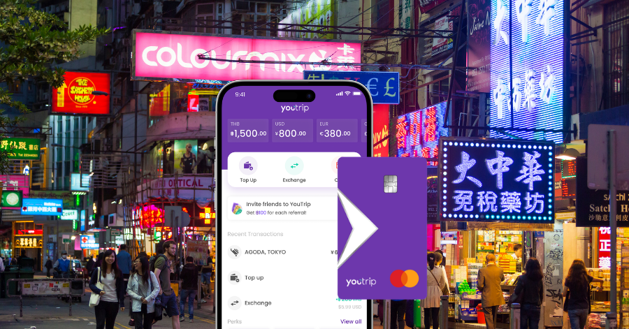 The YouTrip app open on a smartphone held against a neon-lit Hong Kong street