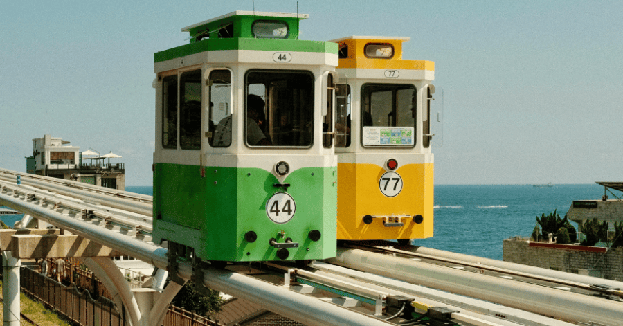 Green and yellow Blue Line Park beach trains on the coastal rail by the sea