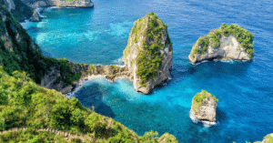 Turquoise cove dotted with limestone islets along Bali's Nusa Penida coast