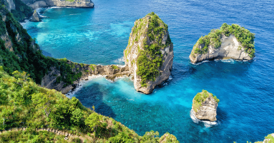Turquoise cove dotted with limestone islets along Bali's Nusa Penida coast