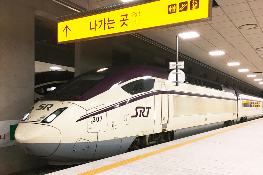 A white SRT high-speed train at a Korean station platform