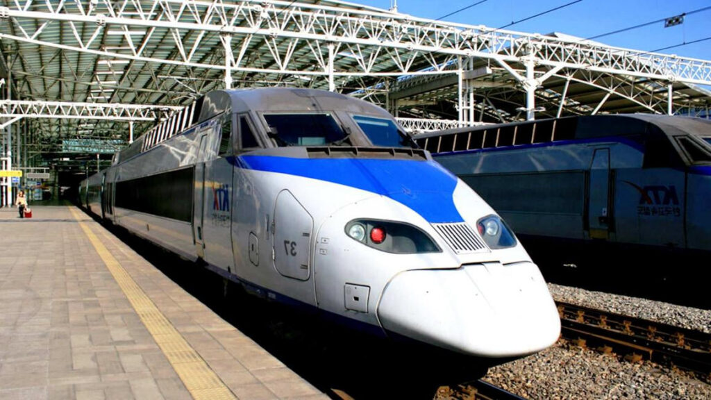 A blue-and-white KTX high-speed train at a Korean station platform