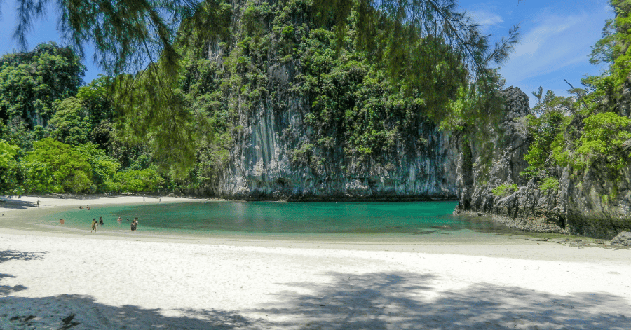 White-sand beach and shallow turquoise lagoon ringed by cliffs at the Hong Islands, Krabi