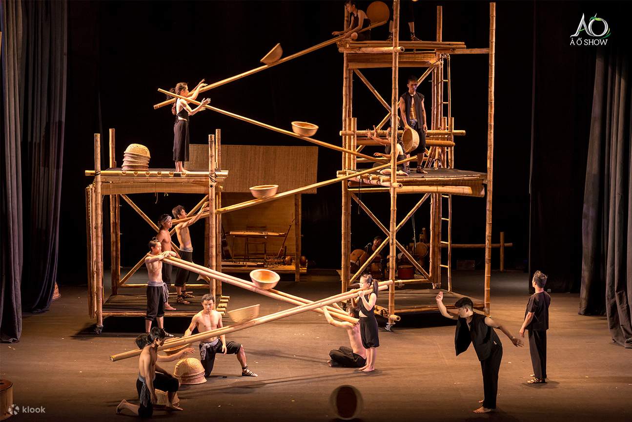Performers and bamboo structures on stage during the A O Show at the Saigon Opera House