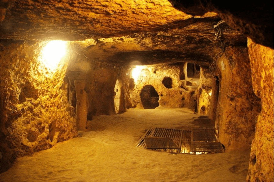 A lit underground earthen passage inside the Cu Chi Tunnels