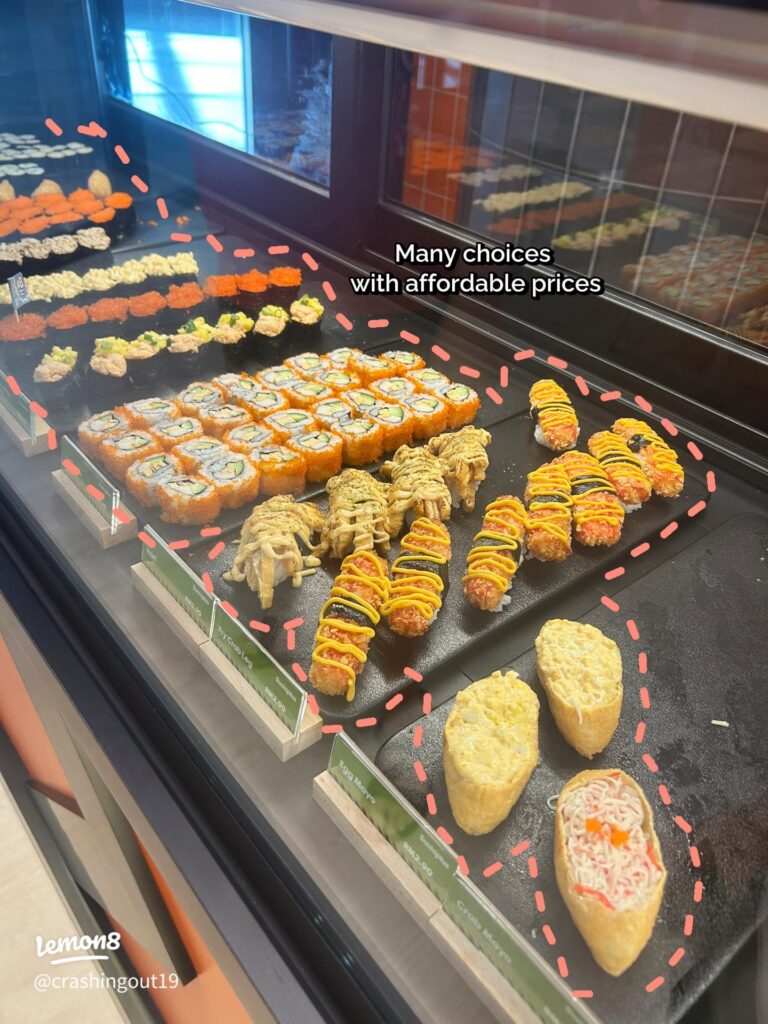 A chilled display case of sushi rolls and nigiri at Empire Sushi