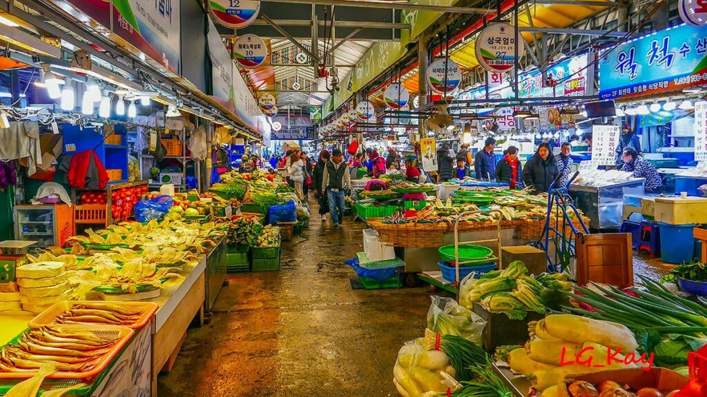Busy covered aisle of Dongmun Traditional Market lined with produce and dried-seafood stalls