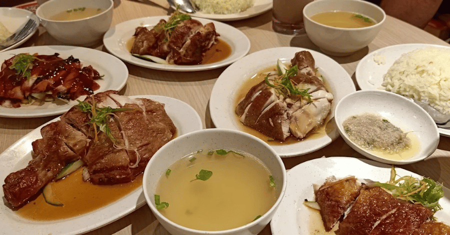 Plates of roast and steamed chicken with rice and soup at The Chicken Rice Shop