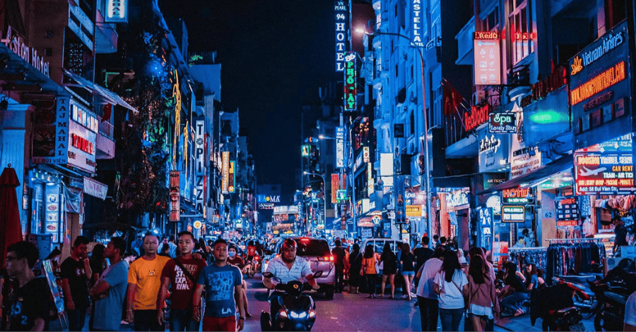 Crowds and neon signs along Bui Vien Walking Street at night in Ho Chi Minh City