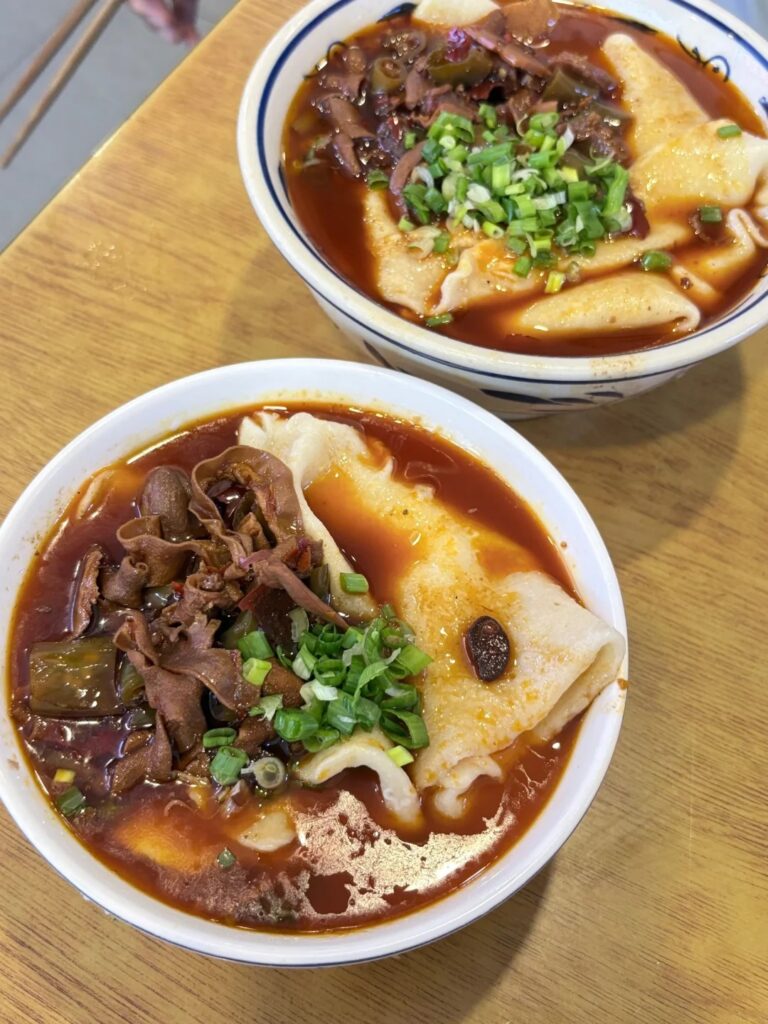 A bowl of hand-pulled Sichuan noodles in a chilli broth, Chengdu