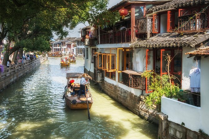 A wooden boat on a canal lined with old waterside houses at Zhujiajiao water town