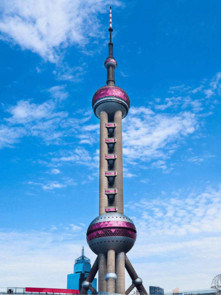 The Oriental Pearl Tower with its pink spheres against a clear blue sky in Pudong, Shanghai