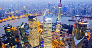 Aerial view of Shanghai's Pudong skyline at dusk, Oriental Pearl Tower and skyscrapers lit along the river