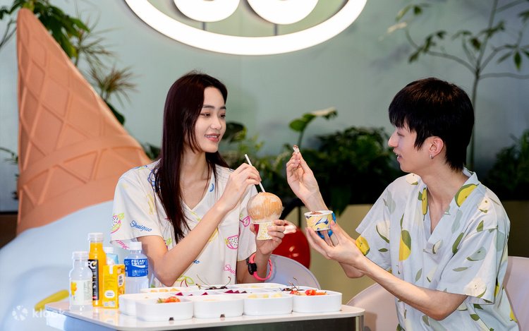 Two people in matching spa robes sharing fruit and ice cream at Shuiguo Hot Spring in Shanghai
